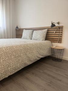 a bedroom with a bed with a lamp on it at Refúgio da Barra in Gafanha da Nazaré