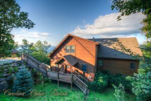 a large wooden house with a large deck at Pinecone Manor Beech Mountain in Beech Mountain