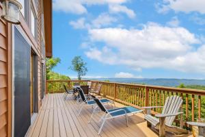 a deck with chairs and a view of the mountains at Pinecone Manor Beech Mountain in Beech Mountain