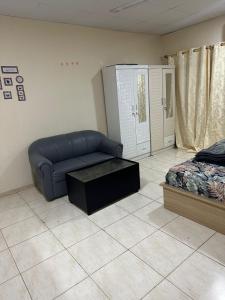 a living room with a couch and a bed at Khan property in Islamabad