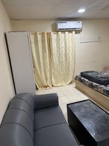 a hospital room with a couch and a window at Khan property in Islamabad