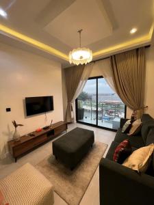 a living room with a couch and a flat screen tv at Pcg Homes in Lagos