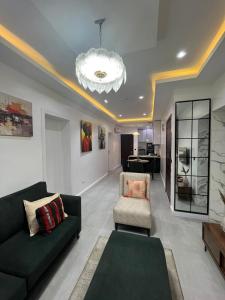 a living room with a couch and a chair at Pcg Homes in Lagos