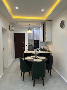 a kitchen and dining room with a table and chairs at Pcg Homes in Lagos +12 photos