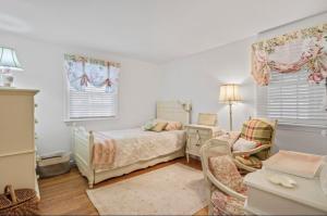 a bedroom with a bed and a desk and a chair at Perfect Cape Escape ! in Harwich