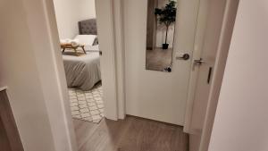 an open door to a bedroom with a bed at Cozy 1 bed executive suit in Surrey