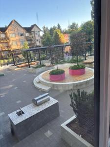 a view of a courtyard with trees and a fountain at Cozy 1 bed executive suit in Surrey
