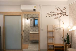 a bathroom with a sink and a mirror at Secret Corner Boutique Stay in Chiang Rai