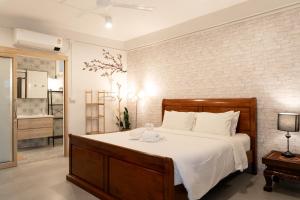 a bedroom with a bed with a teddy bear on it at Secret Corner Boutique Stay in Chiang Rai