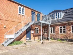a staircase on the side of a brick building at Holiday home in Ringkobing in Ringkøbing