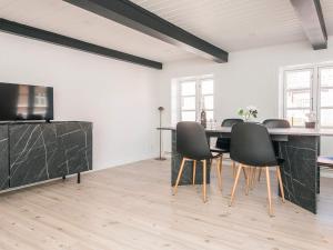 a dining room with a table and chairs at Holiday home in Ringkobing in Ringkøbing