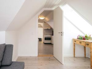 an attic hallway with a door leading into a kitchen at Holiday home in Ringkobing in Ringkøbing