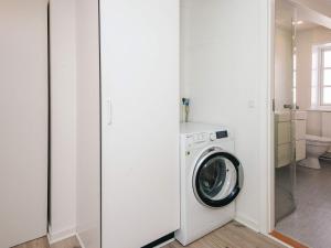 a white laundry room with a washing machine at Holiday home in Ringkobing in Ringkøbing +13 photos