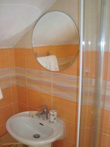 a bathroom with a sink and a mirror at Apartment Adela in Kotor