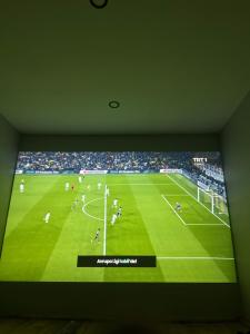 a television screen with a soccer game on a field at İstiridye Bungalov in Samsun +8 photos
