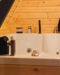 a sink in a bathroom with a wooden ceiling at İstiridye Bungalov in Samsun