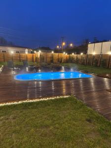 a swimming pool in a yard at night at İstiridye Bungalov in Samsun