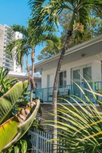 two palm trees in front of a house at Green Island Inn in Fort Lauderdale