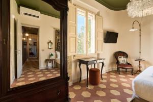 a bedroom with a bed and a desk and a window at Boutique Apartment nel Borgo - Casa Olga e Casa Ilde - Le Dimore del centro in Santarcangelo di Romagna
