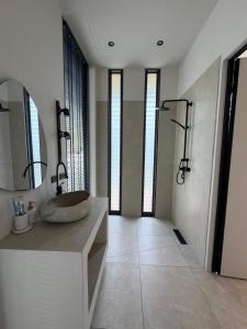 a bathroom with a sink and a large mirror at Wave Villa New 2BR Pool Villa in Ko Phangan +20 photos