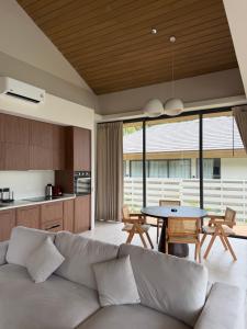 a living room with a couch and a table at Wave Villa New 2BR Pool Villa in Ko Phangan