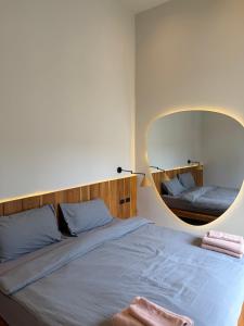a bedroom with a bed with a large mirror at Wave Villa New 2BR Pool Villa in Ko Phangan