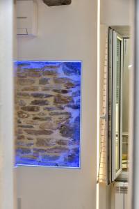 a painting on a wall next to a window at Mezza Galea in Vernazza
