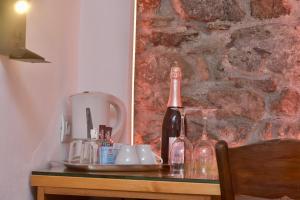 a table with a bottle of wine and glasses on it at Mezza Galea in Vernazza +36 photos