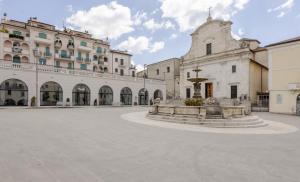 a courtyard with a fountain in front of a building at Central Lux - Casa Caracciolo in Castel di Sangro