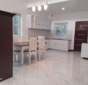 a kitchen with a table and chairs in a room at Lui my happy place in Pandan +16 photos