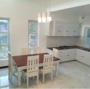 a kitchen with a dining room table and chairs at Lui my happy place in Pandan