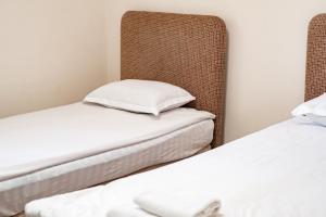 two beds sitting next to each other in a room at Алматы Транзит №1 in (( Turksib ))