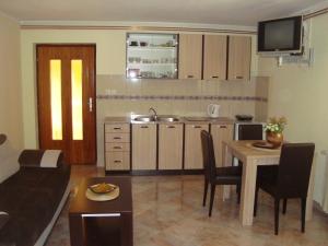 a kitchen and a living room with a table and a couch at Apartment Adela in Kotor