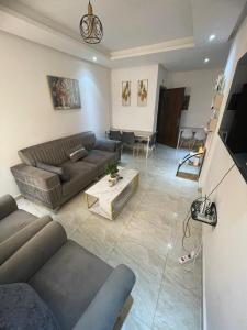 a living room with a couch and a table at The Sonu Nest in Dakar