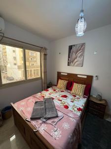 a bedroom with a large bed with a pink comforter at The Sonu Nest in Dakar