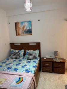 a bedroom with a bed and a dresser with a bed sidx sidx at The Sonu Nest in Dakar +5 photos