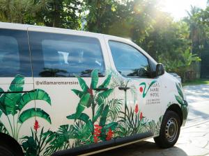 a van with a flower painted on the side of it at Villa'l Mare Hotel in Maresias