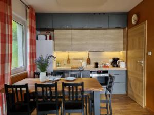 a kitchen with a large wooden table and chairs at Siedlisko Rogówko in Rogówko