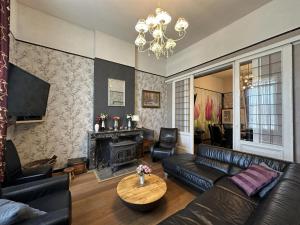 a living room with a couch and a fireplace at La Tulipe in Vireux-Molhain