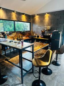 a kitchen with a table and chairs in a room at Loft at Rawaï Beach in Nai Harn Beach