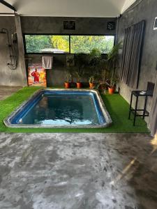 a swimming pool in the middle of a yard at Loft at Rawaï Beach in Nai Harn Beach