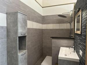 a bathroom with a sink and a toilet and a mirror at La Tulipe in Vireux-Molhain +45 photos