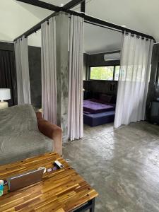 a living room with a couch and a table at Loft at Rawaï Beach in Nai Harn Beach