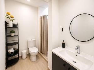 a bathroom with a sink and a toilet and a mirror at Hostal Boutique Zona Rosa - San Benito in San Salvador +26 photos