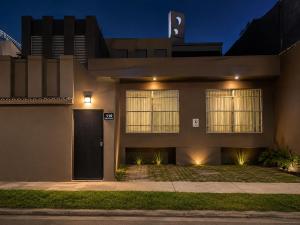 a house with a black door at night at Hostal Boutique Zona Rosa - San Benito in San Salvador