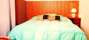 a bedroom with a bed with a red wall at Hospedaje Totocha Yanahuara Arequipa in Yanahuara