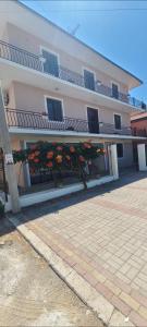 a large pink building with flowers in front of it at ℰ`ℋ Hotel - Velipoje rruga nr 7 in Velipojë +35 photos