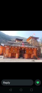 a picture of a building under construction on a television screen at Chaukhamba Pine Cottage & HomeStay in Rānsi +18 photos