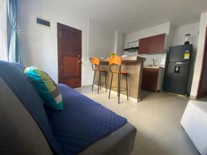 a living room with a couch and a kitchen at Shekinah House in Cartagena de Indias