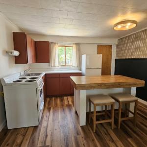 a kitchen with a white stove and a refrigerator at Lakeside Heritage Resort in Carp Lake